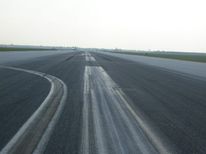 Photo 01. Black Skid Marks Near the Point of Touchdown on Runway 22R.