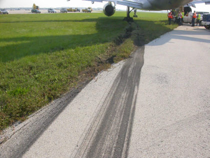 Photo 04. Tire Marks Leading Off Side of Runway.