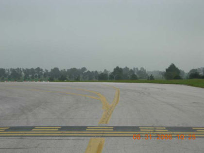 Photo 26. View from T/W A of the hold short position for runway 26