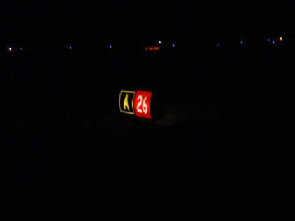 Photo 29. T/W A holding position sign for runway 26 as viewed from a 15-passenger van