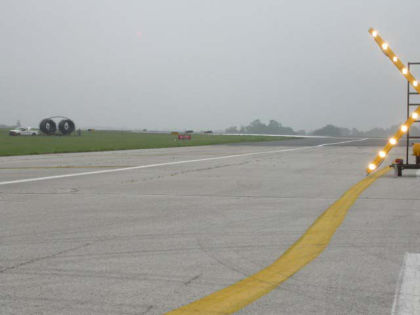Photo 35. Runway 26 with the runway 4/22 intersection sign, lead-off line, white edge