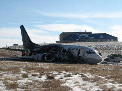 Photograph 4: Right side of airplane, with ARFF 4 fire station in the background.