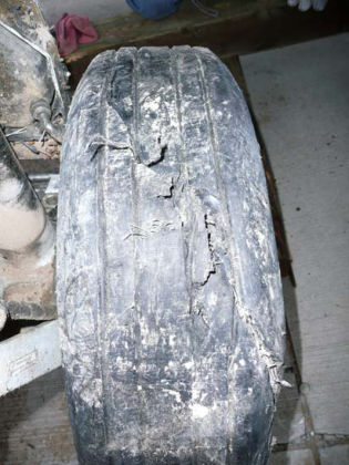 Figure 4 - Photograph of the rupture in the right nose gear tire (left)