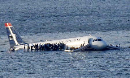 Photo 5. Passengers on the right wing and in the slide/rafts prior to arrival of the ferries