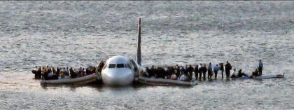 Photo 6. Passengers on the wings and in the slide/rafts prior to arrival of the ferries