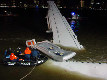 Photo 18. Condition of the airplane and left offwing slide when NTSB investigators