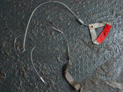 Photo 25. Manual inflation lanyard and ditching release handle found on the floor in the