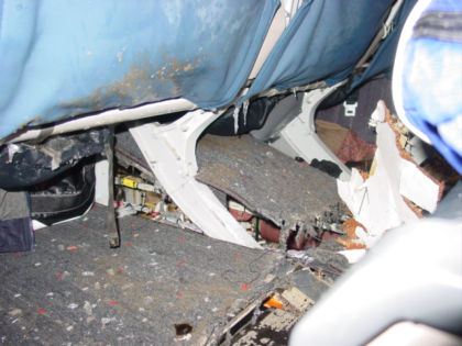 Photo 35. View of the floor damage beneath seat 22E (viewed from row 23 DEF)