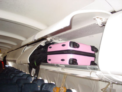 Photo 37. Forward-facing view of the two overhead bins with fractured hinges
