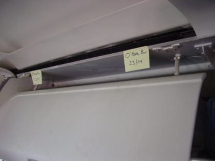 Photo 39. Fractured hinges of overhead bin at row 23/24 DEF