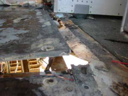 Photo 51. Damage to the center floor panel of the aft galley and surrounding area
