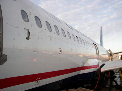 Photo 7 — Left hand side forward fuselage damage aft of the L1 door.