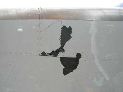 Photo 28 — Right hand horizontal stabilizer lower skin panel fracture.