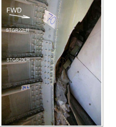 Photo 40 — Aft Pressure Bulkhead. Note the edge of the primary fracture is bent aft