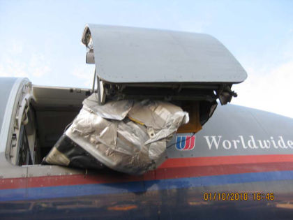 2. Photograph looking directly up at the 1R door. Note: The slide is pinched between the slide’s decorative cover and the aft part of the 1R door.