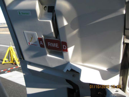 6. View 1R evacuation slide arming handle in the ARMED position.