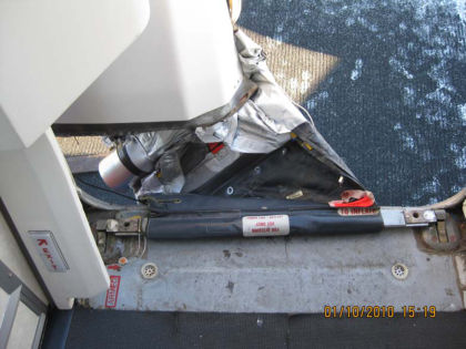 7. View of the 1R evacuation slide from the interior 1R doorway. Note: The aft side of the slide is stretched tight between the girt bar and the decorative