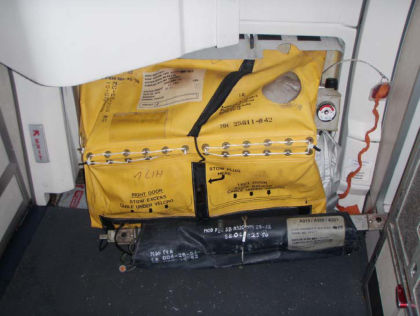 3. View of the 1R evacuation slide as observed after UAL (closed the 1R door) moved N816UA to its hangar at EWR. (Note: the decorative cover is removed and it’s girt bar is not engaged in the floor