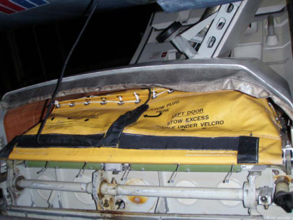 6. View of the 1R slide pack lacing cover cables that separated from the lacing cover (thereby releasing the evacuation slide from its pack.)