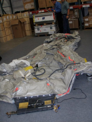1. Photograph of inverted 1R slide/raft (bottom facing up) Note: Yellow oval shows the thin sea anchor line between the pouch and aft aspirator.