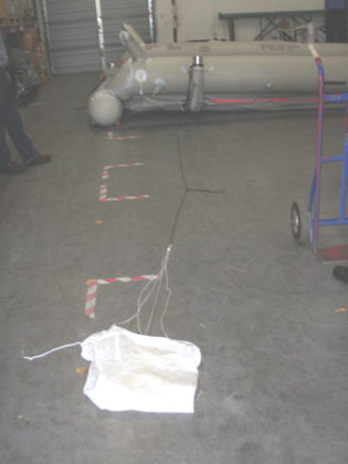 8. Photograph of the 1R slide/raft with the sea anchor removed from the aspirator Note: The slide/raft lower tube partially deflated.