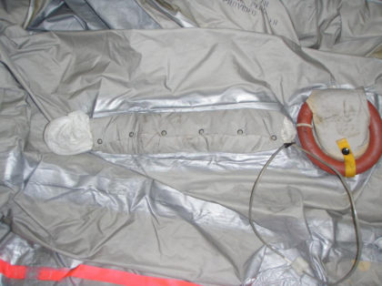 9. Photograph of the 2L slide/raft sea anchor pouch and stainless steel cable secured to the slide.