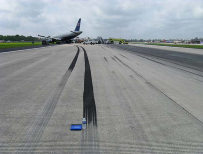 Figure 2. The water bottle is where the overhead photo in Figure 1 is labeled “Heavy Braking Begins – Left Turn.” The white pickup truck is parked on the tire marks that lead to the right set of tires, also shown at the pair of white arrows