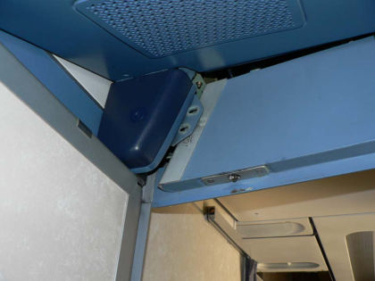 Figure 7. Panel over the cockpit door was missing screws, allowing the panel to descend