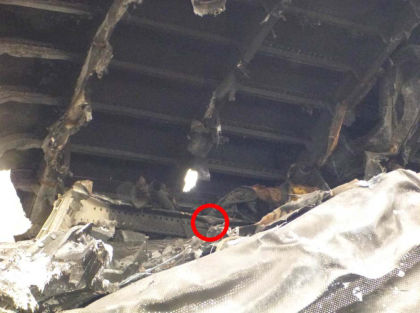 Photo 16. Damage to overhead bin support rail aft of door 2L.