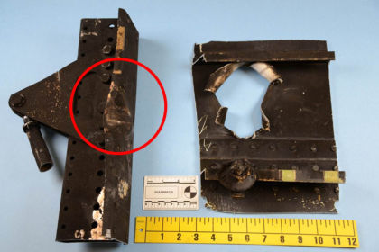 Photo 17. Damage to overhead bin support rail aft of door 2L.