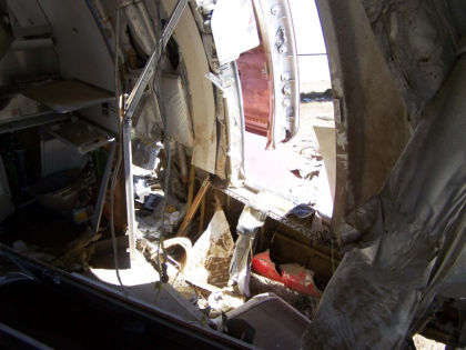 Photo 46. Door 4R slide/raft girt bar and torn girt. (left)