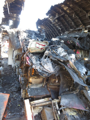 Photo 83. Forward-facing view of B-zone center seats with ceiling debris