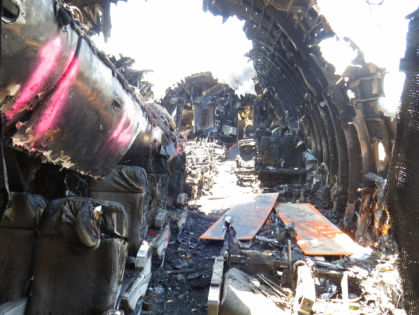 Photo 84. Aft-facing view of B-zone seats from left aisle near row 11 after debris removal.