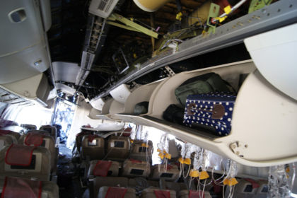 Photo 94. Forward-facing view of C-zone overhead bins in left aisle near row 38.