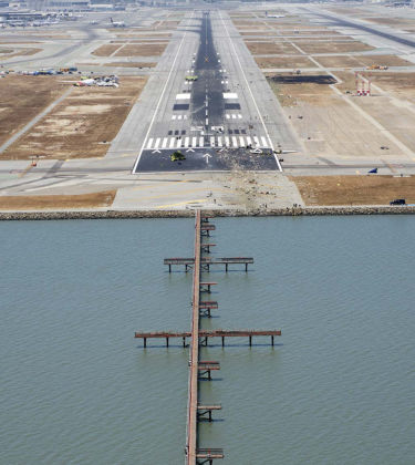 Photo 1: HL7742 wreckage viewed east to west on runway 28L.