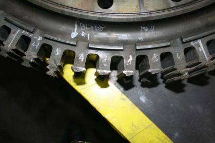 Photo 1: Close up of 2nd stage turbine hub showing fractured lugs Nos. 2 through 5 (P&W)