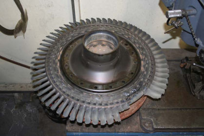 Photo 5: 2nd stage hub with 2nd stage turbine blades showing missing blades, blades fractured