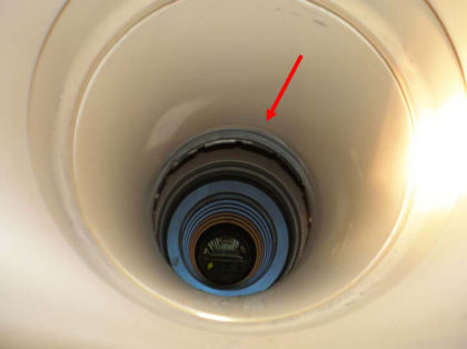 Photo 10: Inside of HPT shaft with arrow showing rub mark The HPT tie rods were all in place and intact. All of the HPT tie rod nuts were tight. The 1st stage turbine disk was intact except for the tangential onboard injector air seal land 