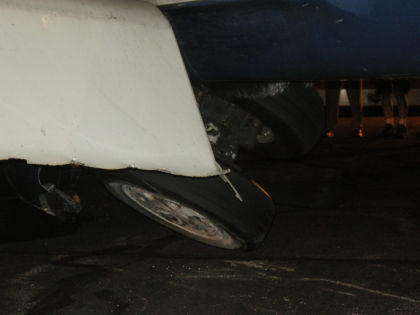 Photo 5: Left Main Landing Gear as Aircraft is Raised with Air Bags (NTSB Digital Photo)