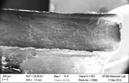 Figure 10: SEM micrographs of the fractured outboard bracket from N369AT; a) Overview of (left)