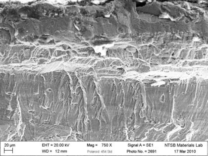 Figure 10: SEM micrographs of the fractured outboard bracket from N369AT; a) Overview of (right)