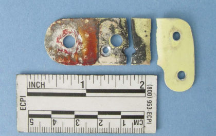 Figure 14: Right elevator inboard lower stop bracket from N414WF. a) After removal from the (left)