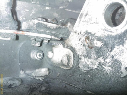 Figure 14: Right elevator inboard lower stop bracket from N414WF. a) After removal from the (right)