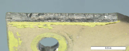 Figure 16: The fracture surface on the lower stop bracket from N414WF. Fatigue cracks were observed initiating along the